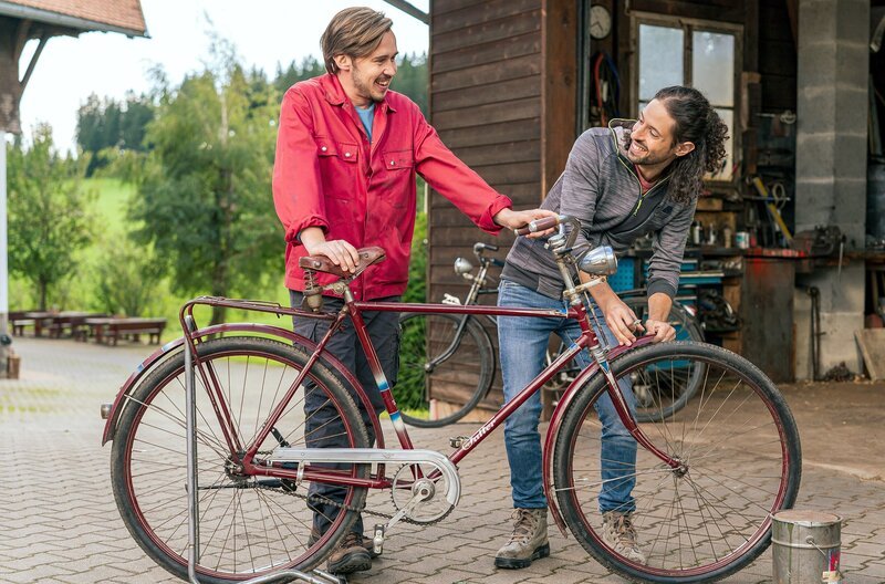 Albert (Alessio Hirschkorn, re.) und Sebastian (Dominik Stricker) legen letzte Hand an bei der Restauration des zweiten Oldtimer-Fahrrades. – Bild: SWR/​Christian Koch