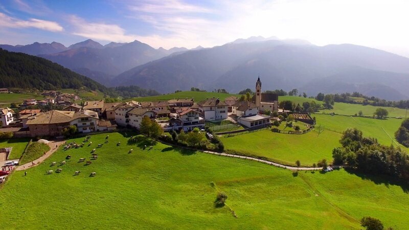 Flugaufnahme von Altrei, im Hintergrund das Fleimstal. – Bild: ORF/​STEFAN NICOLINI