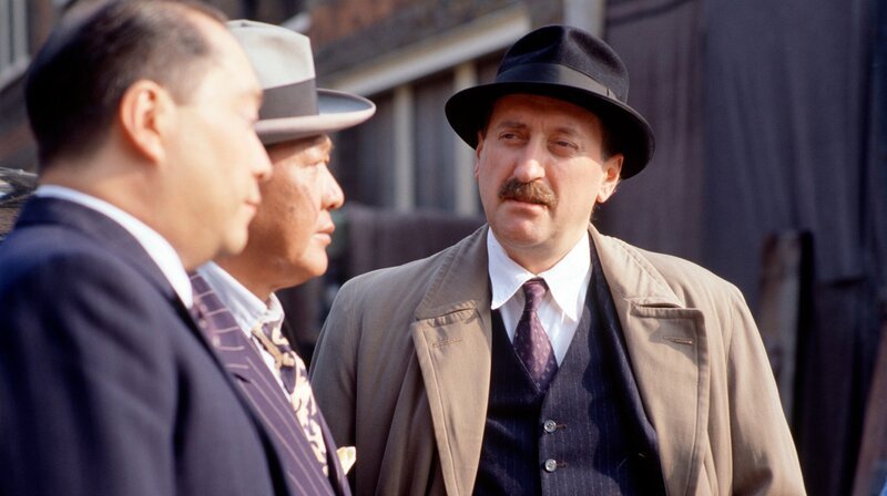 Chief Inspector Japp (Philip Jackson, r) befragt Passanten. – Bild: WDR/​ITV plc (Granada International)