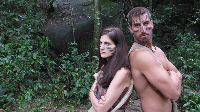 Lindsay Garrison and Matt Wright with their backs up against each other with war paint on their faces in Thailand. – Bild: Discovery Communications
