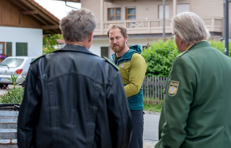 Hubert (Christian Tramitz, l.) und Girwidz (Michael Brandner, r.) befragen Mark Neumayr (Thilo Prothmann, M.) zu seinem Alibi. – Bild: ARD/​Thomas Neumeier