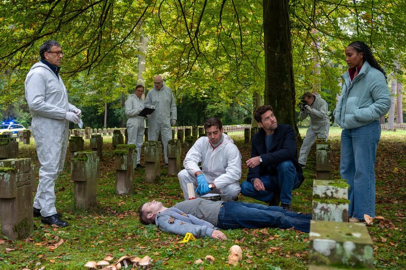 Als Darius Popescu (Komparse, liegend) getötet auf dem Friedhof aufgefunden wird, sind der Leiter der KTU Jan Arnaud (Mike Zaka Sommerfeldt, l.) und Rechtsmediziner Dr. Benedikt Förster (Florian Wünsche, 2.v.l.) überrascht: Er wurde mit einem Holzpflock in der Brust umgebracht. Für die Kommissare Jo Stoll (Peter Ketnath, 2.v.r.) und Toni Kidane (Iman Tekle, r.) beginnt eine außergewöhnlich düstere Ermittlungsarbeit. – Bild: ZDF und MARKUS_FENCHEL